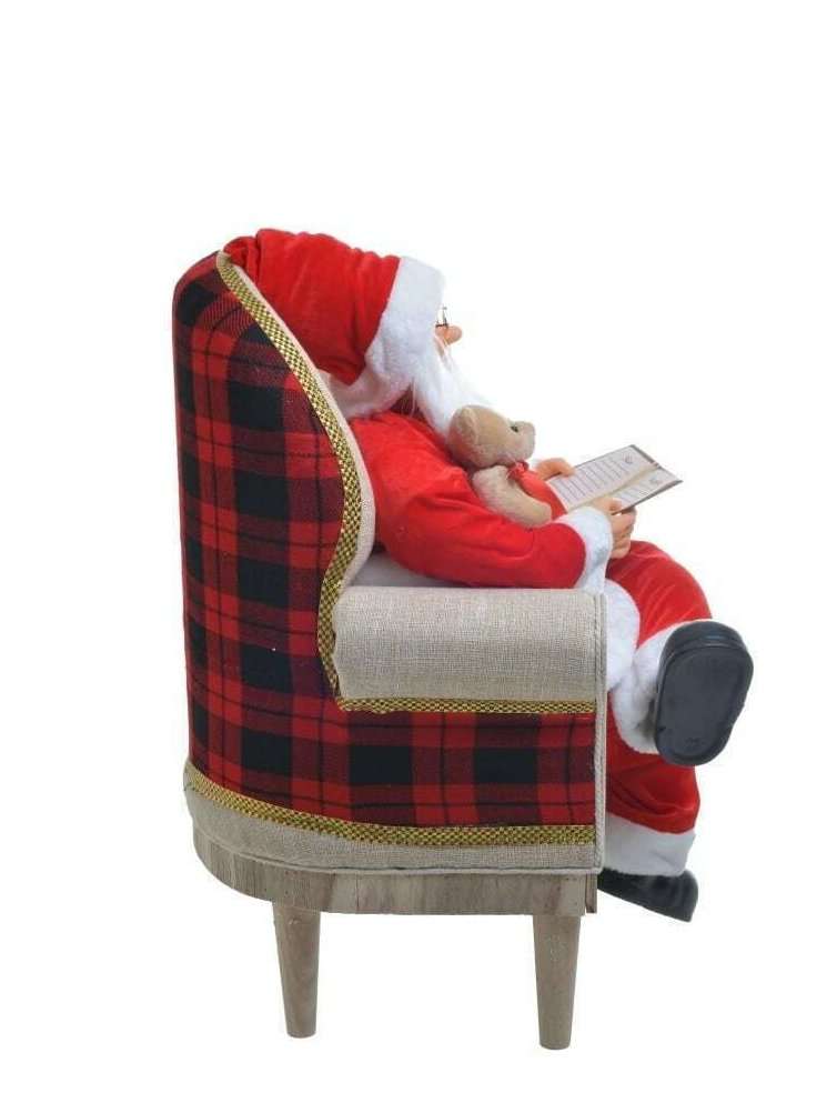 Babbo Natale Sulla Poltrona Con Quaderno E Orsacchiotto