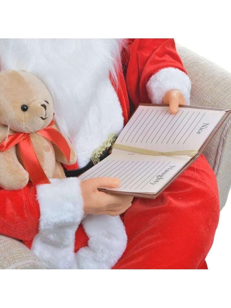 Babbo Natale Sulla Poltrona Con Quaderno E Orsacchiotto